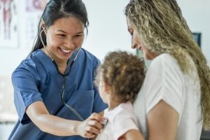 nurse with little girl and her mom
